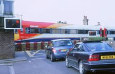 Traffic queue at level crossing in Brockenhurst, Hampshire