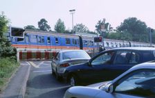 Traffic queue at level crossing in Brockenhurst, Hampshire