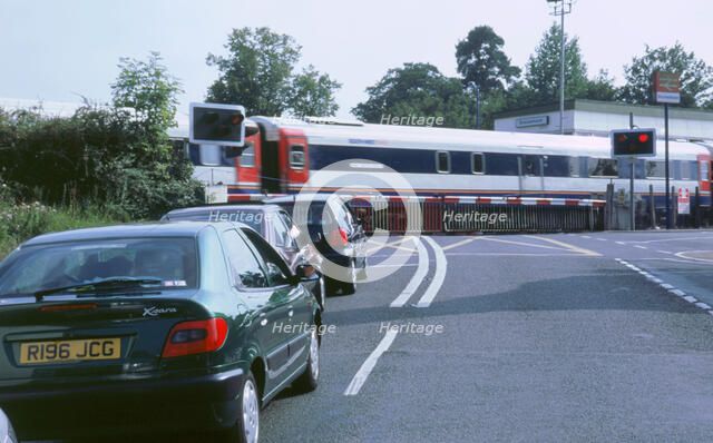 Traffic queue at level crossing in Brockenhurst, Hampshire. Artist: Unknown.