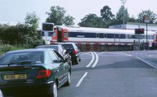 Traffic queue at level crossing in Brockenhurst, Hampshire