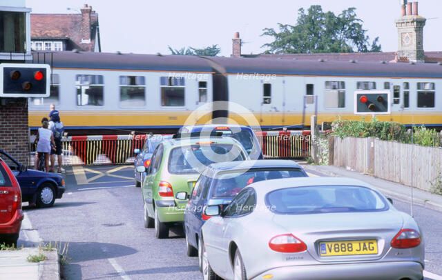 Traffic queue at level crossing in Brockenhurst, Hampshire. Artist: Unknown.