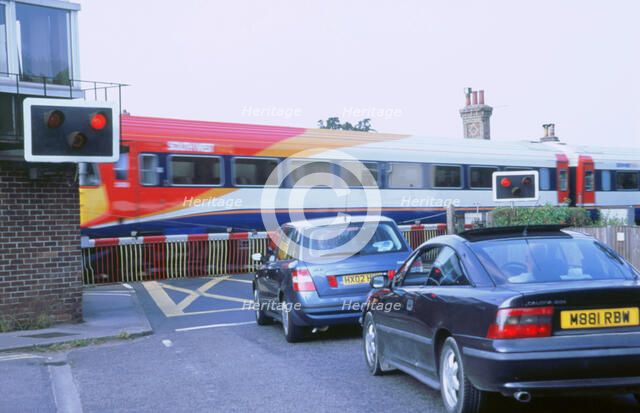 Traffic queue at level crossing in Brockenhurst, Hampshire. Artist: Unknown.