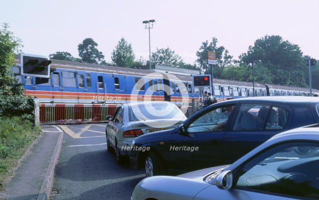 Traffic queue at level crossing in Brockenhurst, Hampshire. Artist: Unknown.