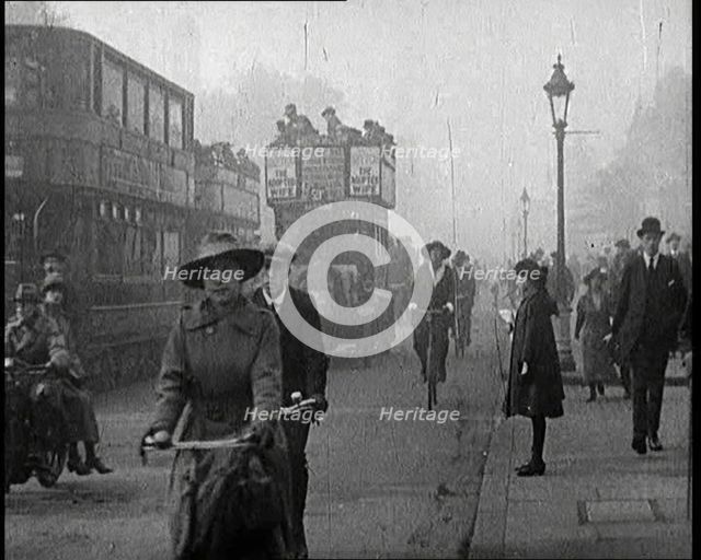 Traffic Scenes in London. Pedestrians, Cyclists, and Motorists All Passing By, 1922. Creator: British Pathe Ltd.