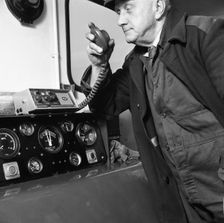Train driver on an intercom, South Yorkshire, 1964. Creator: Michael Walters