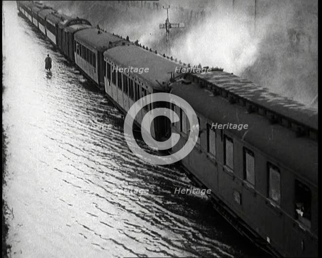 Train Driving Through Flooded Fields and Tracks, 1926. Creator: British Pathe Ltd.