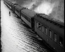Train Driving Through Flooded Fields and Tracks, 1926. Creator: British Pathe Ltd