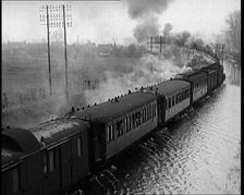 Train Driving Through Flooded Fields and Tracks, 1926. Creator: British Pathe Ltd