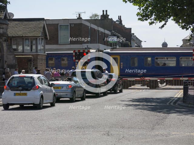 Train passing through level crossing in Lincoln 2014 Artist: Unknown.