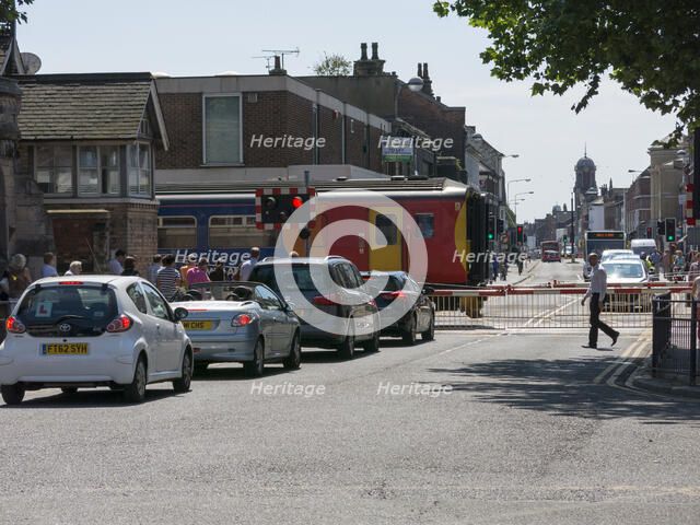 Train passing through level crossing in Lincoln 2014 Artist: Unknown.
