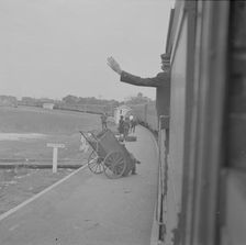 Trainman signalling from a "Jim Crow" coach, Saint Augustine, Florida, 1943. Creator: Gordon Parks