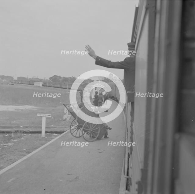 Trainman signalling from a "Jim Crow" coach, Saint Augustine, Florida, 1943. Creator: Gordon Parks.