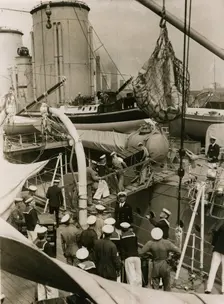 Transfering cases from H.M.S. Suffolk to H.M.S. Hood at Portsmouth, July 1935. Creator: Topical Press Agency