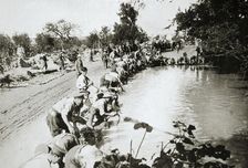 Transport men cleaning their harness at a pond after wet weather, France, World War I, 1916