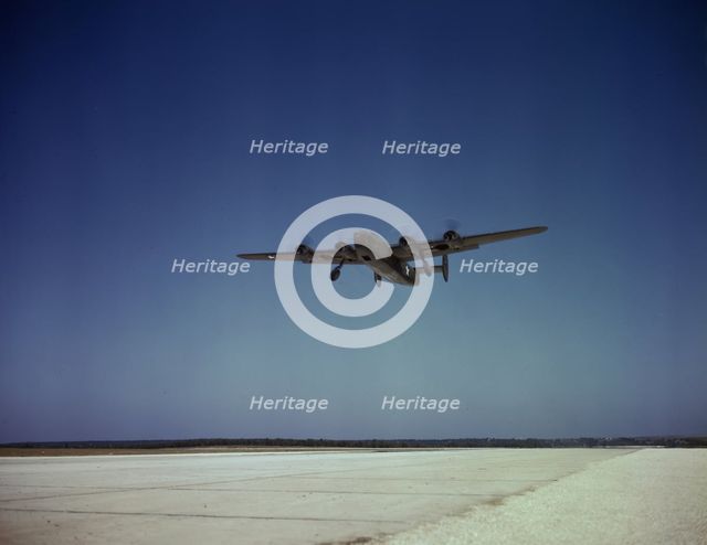 Transport plane takes off on test flight, Consolidated Aircraft Corp., Fort Worth, Texas, 1942. Creator: Howard Hollem.
