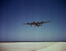 Transport plane takes off on test flight, Consolidated Aircraft Corp., Fort Worth, Texas, 1942. Creator: Howard Hollem