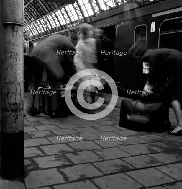 Travellers boarding a train to Rotterdam, Centraal Station, Amsterdam, Netherlands, 1963. Artist: Michael Walters