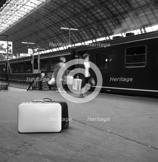 Travellers on a platform, Centraal Station, Amsterdam, Netherlands, 1963. Creator: Michael Walters.