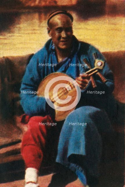 Travelling musician, China, c1928. Creator: Unknown.