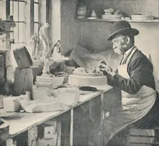 Trimming up parts of raw clay c1917