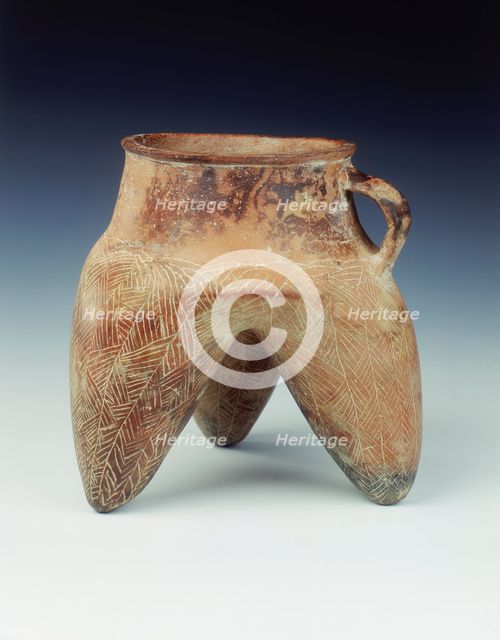 Tripod jar with strap handle and hollow legs, Qijia culture, Qinghai province, China, 1800-1500 BC. Creator: Unknown.