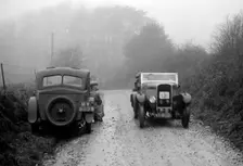 Triumph of J Cramer-Parry passing an official's Riley, MCC Exeter Trial, Blackhill, Dorset, 1930. Artist: Bill Brunell