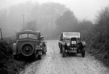 Triumph of J Cramer-Parry passing an official's Riley, MCC Exeter Trial, Blackhill, Dorset, 1930. Artist: Bill Brunell