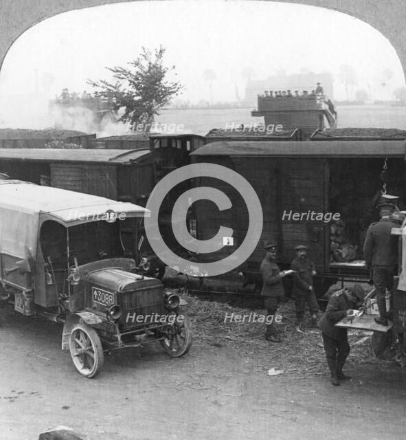 Troops and supplies are rushed from a railhead to the firing line, World War I, c1914-c1918. Artist: Realistic Travels Publishers