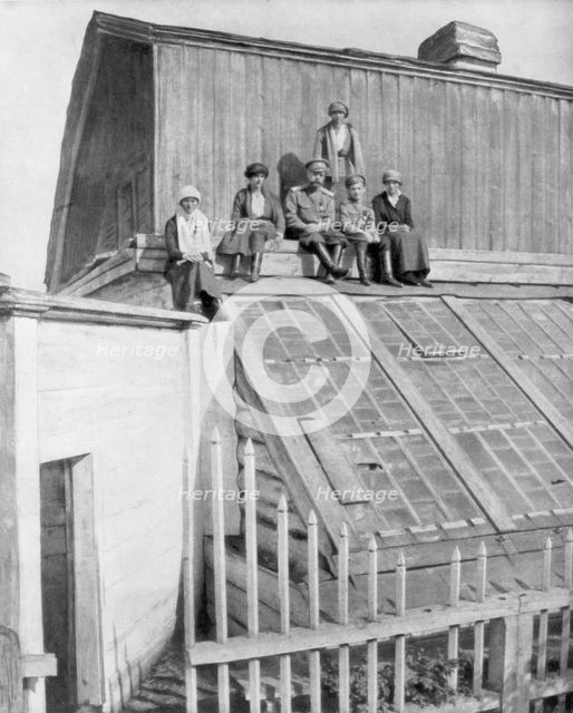 Tsar Nicholas II and his children sitting on a greenhouse, Tobolsk, Siberia, Russia, 1917. Artist: Unknown