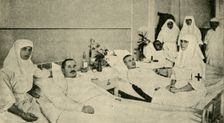 Tsarina Alexandra nursing wounded soldiers, 1914, (c1920). Creator: Unknown