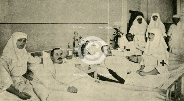 Tsarina Alexandra nursing wounded soldiers, 1914, (c1920). Creator: Unknown.