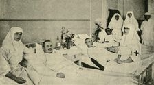 Tsarina Alexandra nursing wounded soldiers, 1914, (c1920). Creator: Unknown