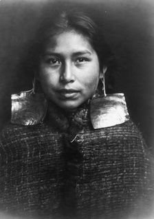 Tsawatenok girl, head-and-shoulders portrait, facing front, c1914. Creator: Edward Sheriff Curtis