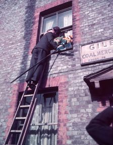 Tutti Man claiming a kiss, Hocktide Festival, Hungerford, Berkshire, c1955. Creator: Arthur Charles Kirby Ware