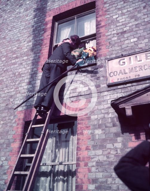 Tutti Man claiming a kiss, Hocktide Festival, Hungerford, Berkshire, c1955. Creator: Arthur Charles Kirby Ware.