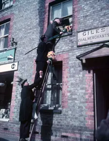 Tutti Men claiming a kiss, Hocktide Festival, Hungerford, Berkshire, c1955. Creator: Arthur Charles Kirby Ware