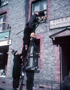Tutti Men claiming a kiss, Hocktide Festival, Hungerford, Berkshire, c1955. Creator: Arthur Charles Kirby Ware