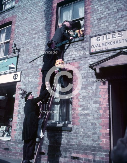 Tutti Men claiming a kiss, Hocktide Festival, Hungerford, Berkshire, c1955. Creator: Arthur Charles Kirby Ware.