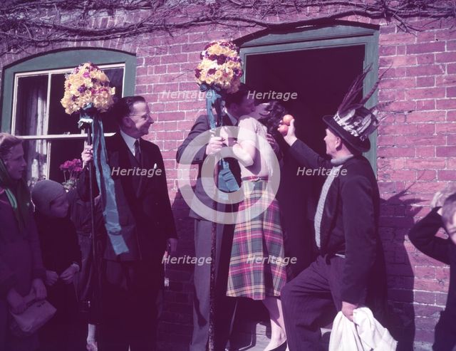 Tutti Men claiming a kiss, Hocktide Festival, Hungerford, Berkshire, c1955. Creator: Arthur Charles Kirby Ware.