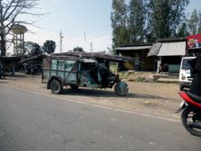 Tutuk carrying load of steel rods on roof, India 2017. Creator: Unknown