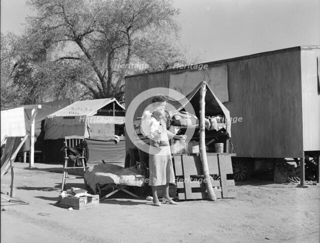 Tubercular mother from Oklahoma now living in the Kern migrant camp (resettlement), CA, 1936. Creator: Dorothea Lange.
