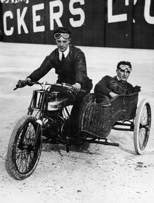 Tudor and Thompson riding a motorcycle and sidecar