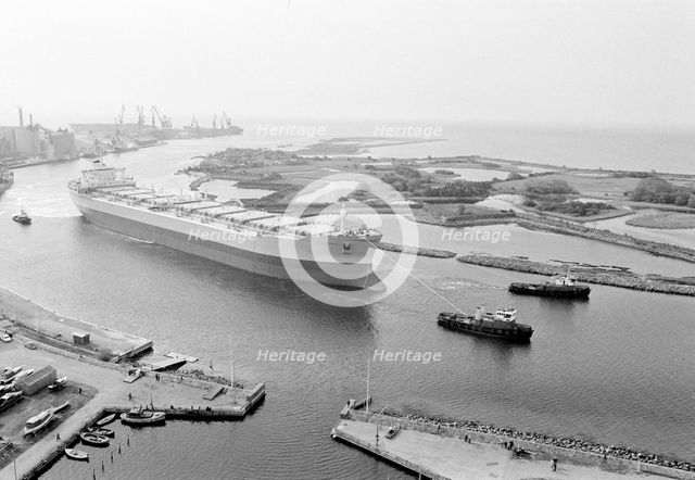 Tugboats assist the M/S 'Varenna' to leave Landskrona shipyard, Sweden, c1970. Creator: Unknown.