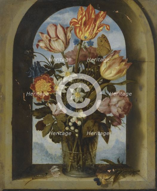tulips, moss-roses, lily-of-the-valley and other flowers in a glass beaker set in an arched stone wi