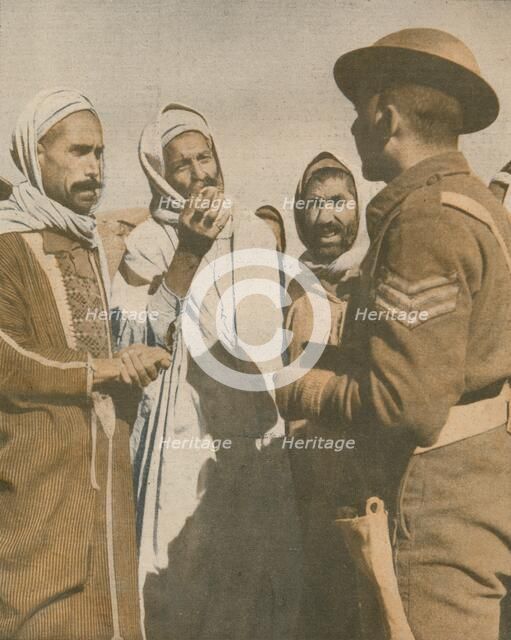 'Tunisian Arabs Welcome a British Sergeant at Chaouach', 1943. Artist: Unknown.
