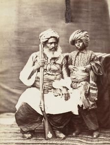 Turbaned Man Holding Rifle with Boy Alongside, 1860s. Creator: Unknown