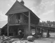 Turpentine still in the Piney Woods near Valdosta, Georgia, 1937. Creator: Dorothea Lange