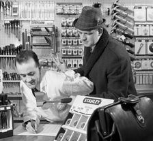 Twist your arm for an order, 1967. Creator: Michael Walters