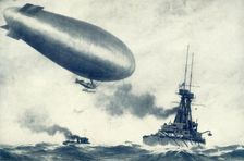 Twixt Sea and Sky. British Airship Towed by Warship 1917. Creator: Unknown