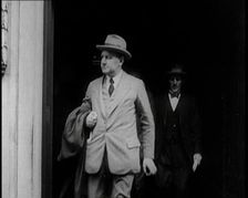 Two Male Civilians Emerging from a Building, 1924. Creator: British Pathe Ltd